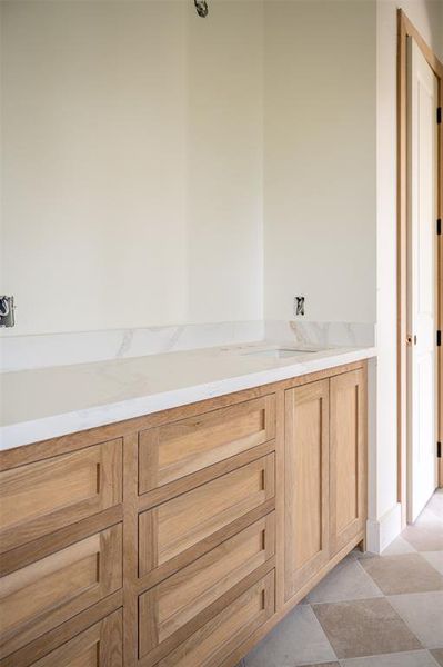 Matching quartz countertops in all bathrooms.