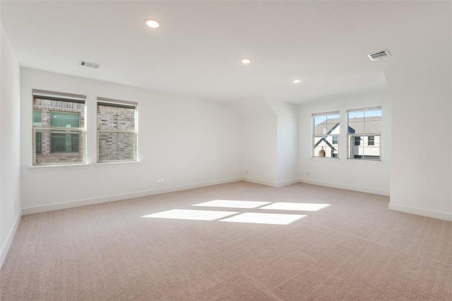 Upstairs lving room with recessed lighting and light carpet Upstairs lving room with recessed lighting and light carpet