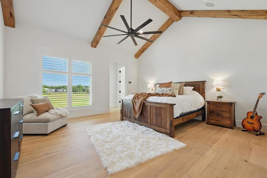 Bedroom featuring light wood finished floors and a ceiling fan Bedroom featuring light wood finished floors and a ceiling fan