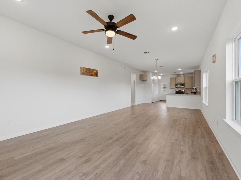 The spacious living room is designed for comfort and connection, with high ceilings and an open-concept layout that keeps everyone together.