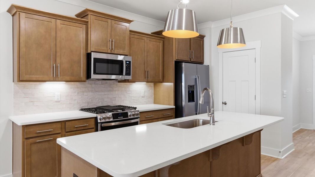 Memorable meals begin in this vibrant kitchen with pendant lighting and a thoughtfully designed island at Pelham Crossing