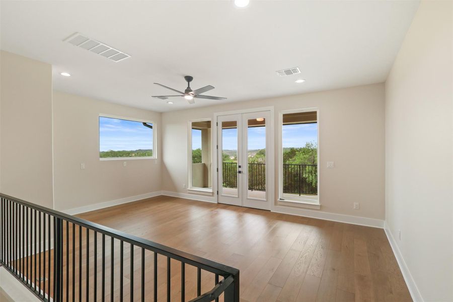 Empty room featuring recessed lighting, ceiling fan, visible vents, baseboards, and wood finished floors Empty room featuring recessed lighting, ceiling fan, visible vents, baseboards, and wood finished floors