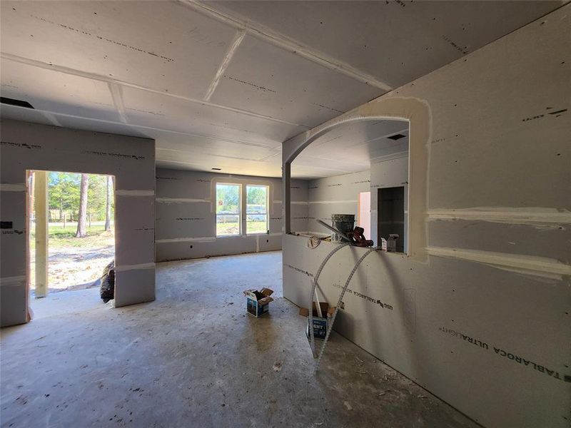 Look Back at Front Door, Kitchen Bar area & Dining Area