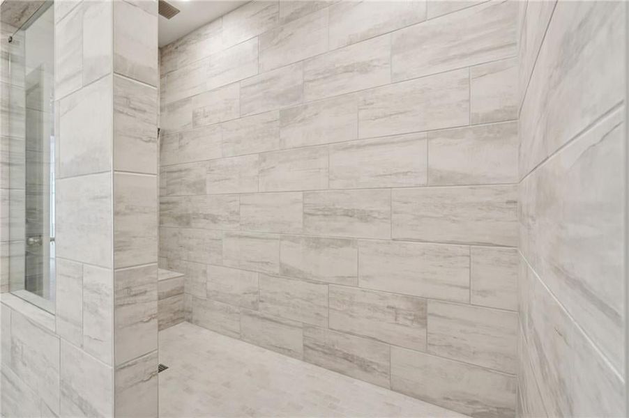 Bathroom featuring a tile shower