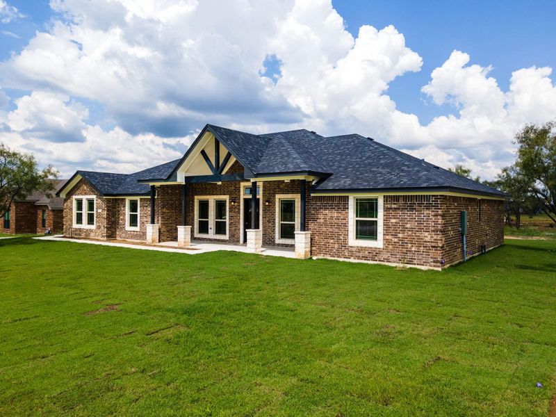 View of front of property with brick veneer, a yard, and roof with shingles View of front of property with brick veneer, a yard, and roof with shingles