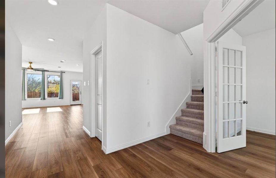 Stairs featuring wood finished floors and recessed lighting