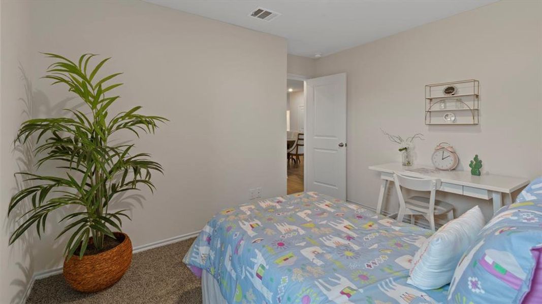 Bedroom featuring dark colored carpet and baseboards