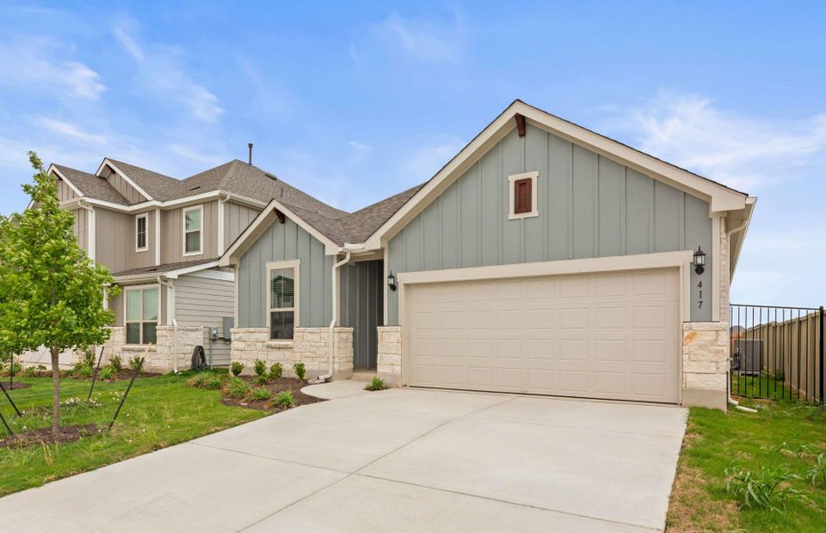Front exterior of a new home in Santa Rita Ranch, Liberty Hill, TX, highlighting curb appeal (Image 25).