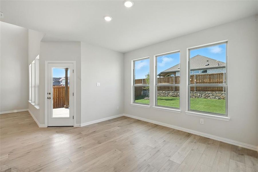 Unfurnished dining area featuring light wood-type flooring and recessed lighting Unfurnished dining area featuring light wood-type flooring and recessed lighting