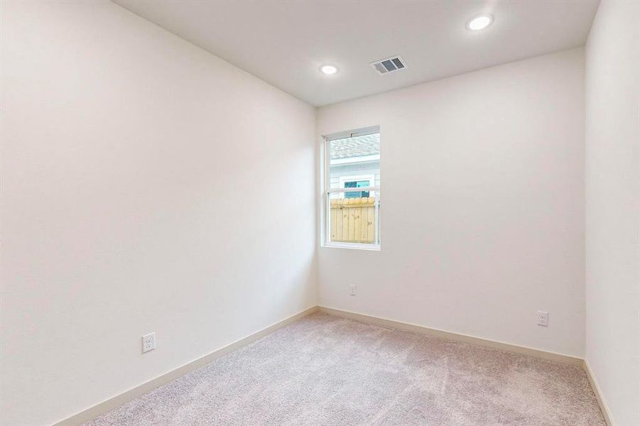 Spare room with recessed lighting, visible vents, light carpet, and baseboards