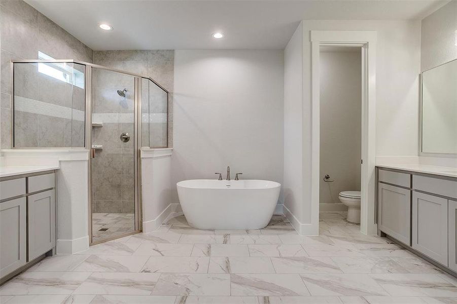 Bathroom with tile patterned floors, toilet, vanity, and a shower with shower door