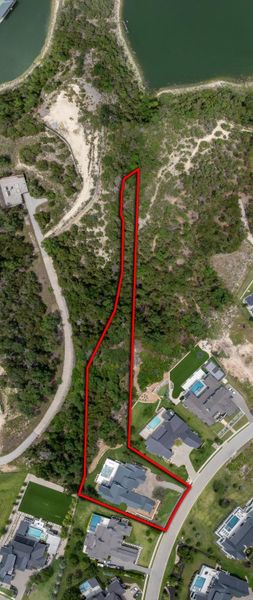 A spacious, undeveloped lot awaits your architectural vision, nestled beside established luxury residences.