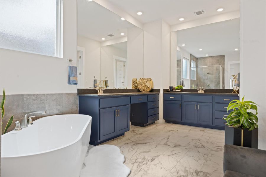 Dual vanities with elegant blue cabinetry Dual vanities with elegant blue cabinetry