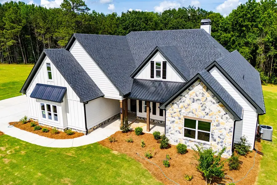 Front exterior of a new home in WOODMONT RESERVE, Roopville, GA, highlighting curb appeal (Image 39).