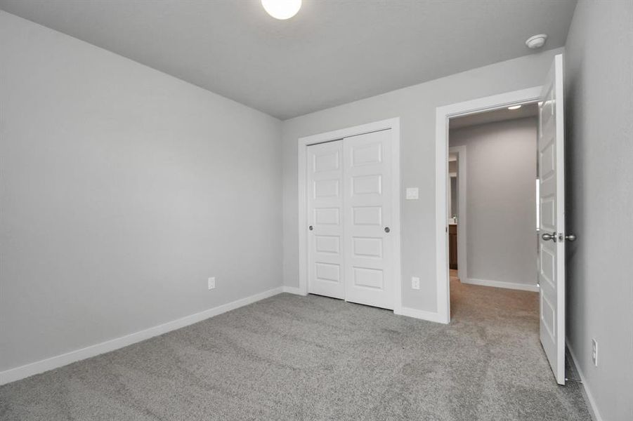 Generously sized secondary bedrooms featuring spacious closets, soft and inviting carpeting underfoot, large windows allowing plenty of natural light, and the added touch of privacy blinds for your personal retreat.