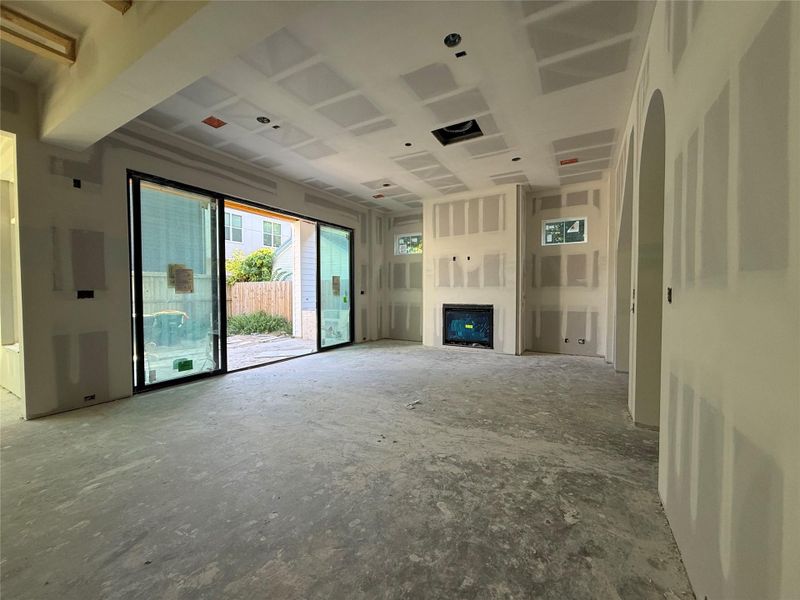 Massive 16' wide biparting sliding door opens to a covered outdoor patio