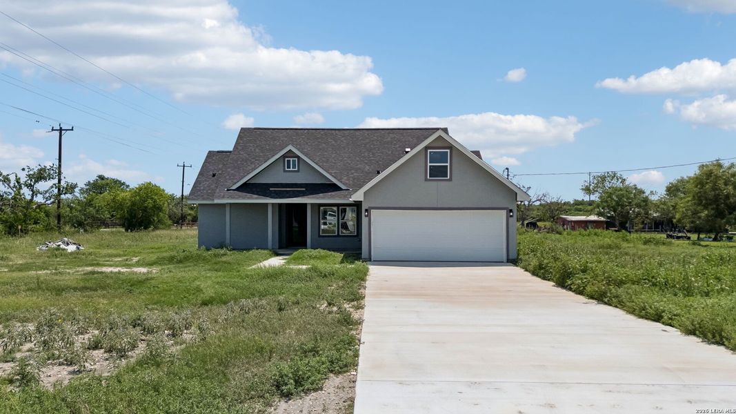 Front exterior of a new home in , Natalia, TX, highlighting curb appeal (Image 18).