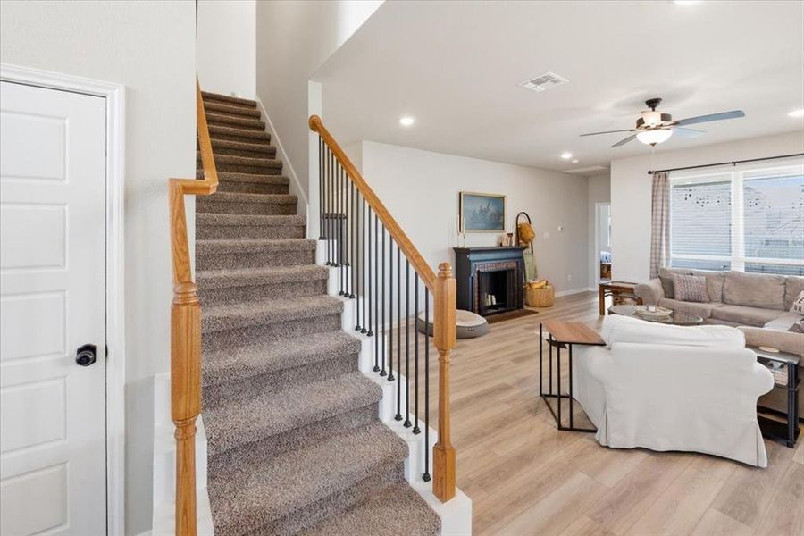 Living room with light wood finished floors, ceiling fan, and recessed lighting Living room with light wood finished floors, ceiling fan, and recessed lighting