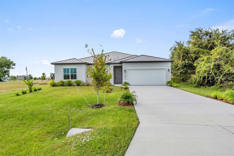 Front exterior of a new home in , Punta Gorda, FL, highlighting curb appeal (Image 1).