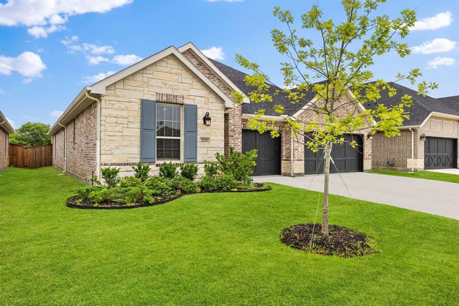 Front exterior of a new home in Valencia On The Lake, Little Elm, TX, highlighting curb appeal (Image 2). Front exterior of a new home in Valencia On The Lake, Little Elm, TX, highlighting curb appeal (Image 2).