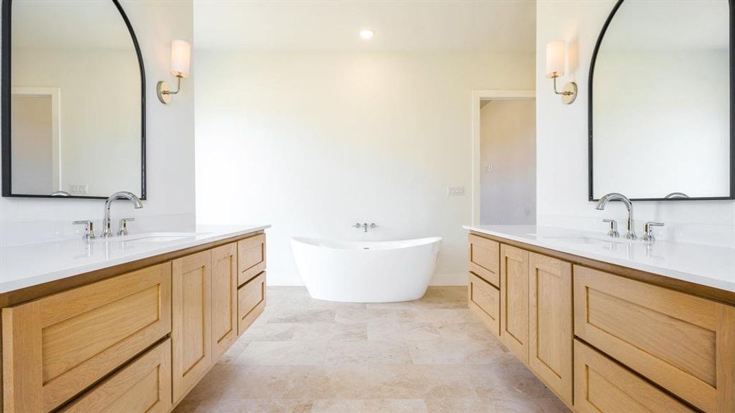 Bathroom with a bath, tile flooring, and dual bowl vanity