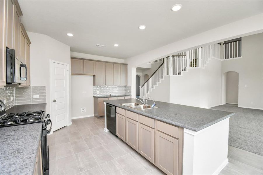 The kitchen overlooks the living room and is perfect for entertaining!