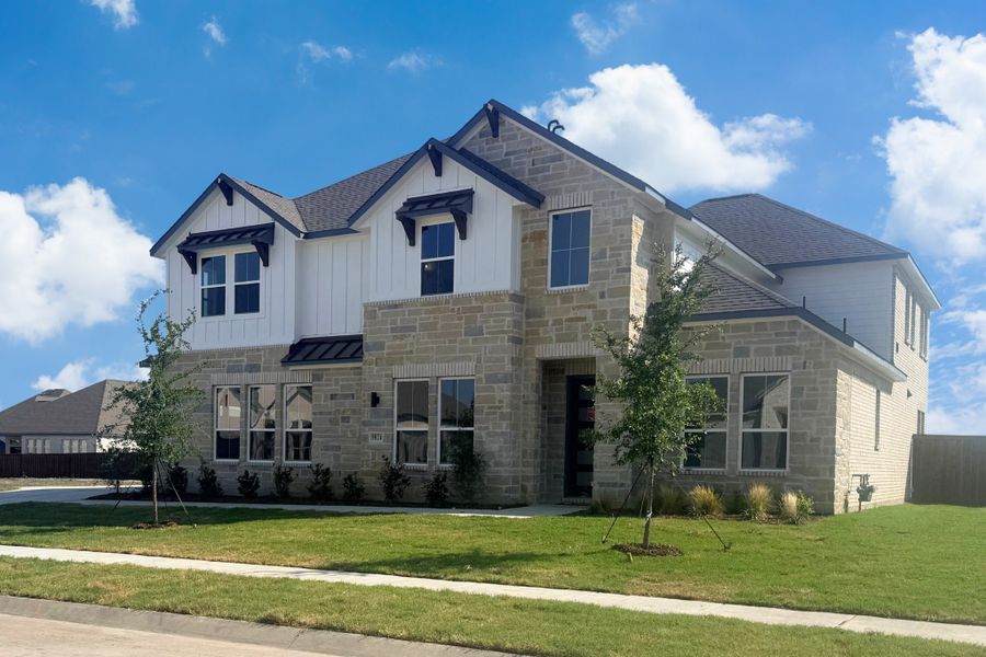 Front exterior of a new home in Polo Ridge, Forney, TX, highlighting curb appeal (Image 2). Front exterior of a new home in Polo Ridge, Forney, TX, highlighting curb appeal (Image 2).