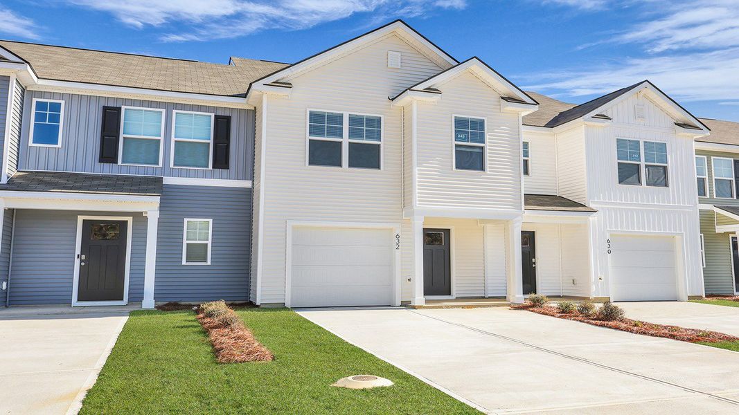 Front exterior of a new home in Pine Hills Townhomes at Cane Bay, Summerville, SC, highlighting curb appeal (Image 2). Front exterior of a new home in Pine Hills Townhomes at Cane Bay, Summerville, SC, highlighting curb appeal (Image 2).