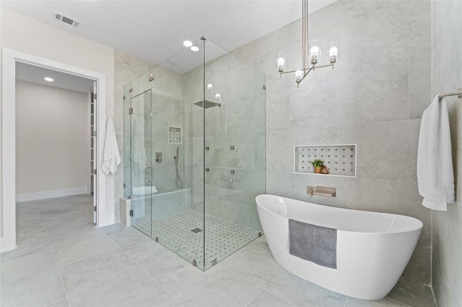 Full bathroom featuring a soaking tub, a shower stall, and recessed lighting Full bathroom featuring a soaking tub, a shower stall, and recessed lighting