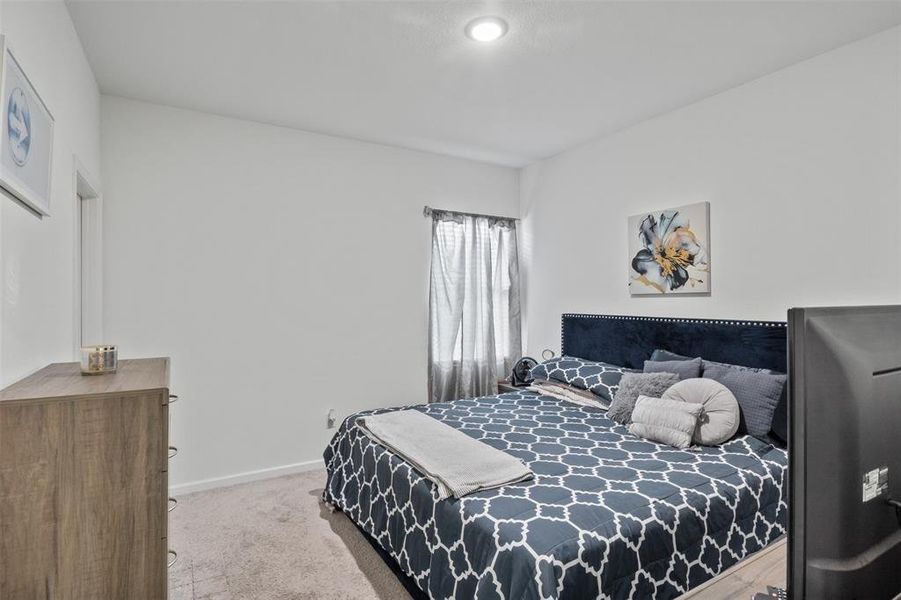 Bedroom with carpet flooring and baseboards