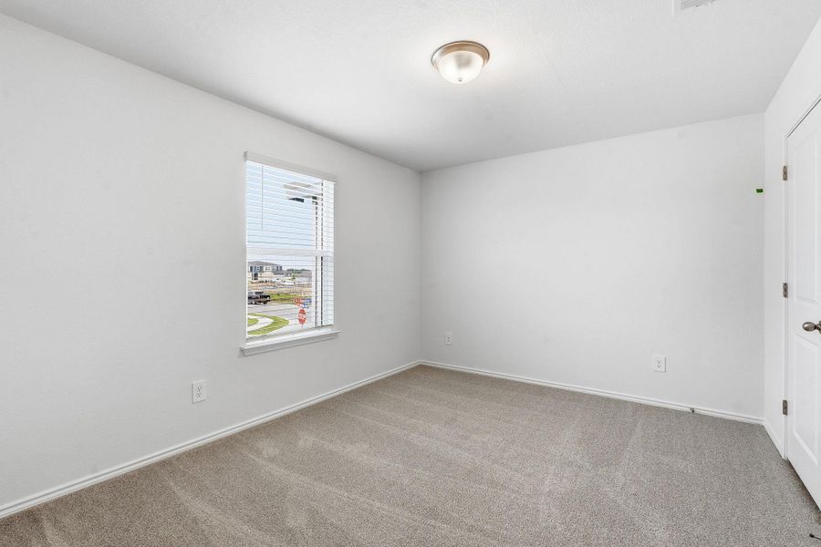 Room featuring neutral carpeting, white painted walls, and a single window with blinds Room featuring neutral carpeting, white painted walls, and a single window with blinds