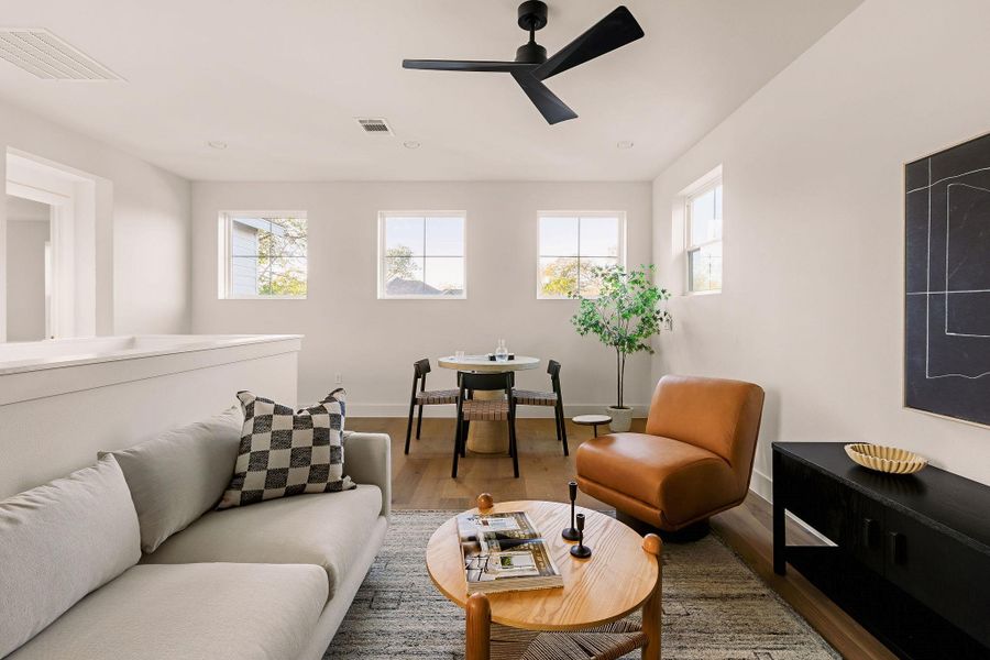 Living area with wood finished floors, a ceiling fan, and recessed lighting Living area with wood finished floors, a ceiling fan, and recessed lighting