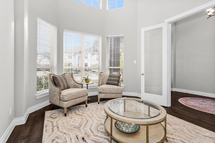 The home office/formal living space with closed off double french doors right off the entry.