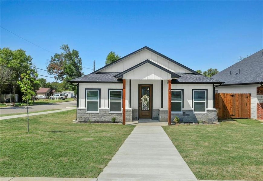 View of front of property with covered porch, board and batten siding, a shingled roof, and stone siding View of front of property with covered porch, board and batten siding, a shingled roof, and stone siding