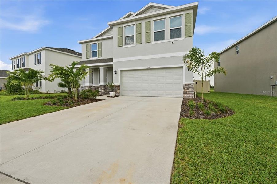 Front exterior of a new home in Solera at Lakewood Ranch, Lakewood Ranch, FL, highlighting curb appeal (Image 2). Front exterior of a new home in Solera at Lakewood Ranch, Lakewood Ranch, FL, highlighting curb appeal (Image 2).