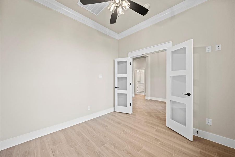 Spare room featuring light wood-style flooring and ornamental molding