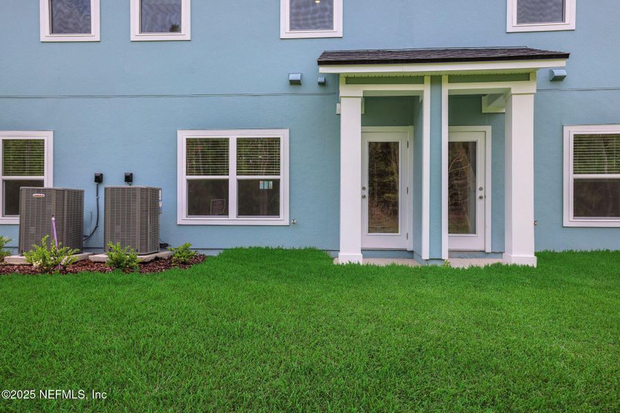 Front exterior of a new home in Atlantis Pointe, Middleburg, FL, highlighting curb appeal (Image 2).