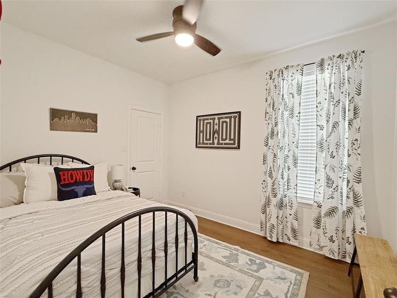 Bedroom with wood finished floors and ceiling fan Bedroom with wood finished floors and ceiling fan
