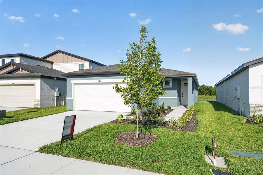 Front exterior of a new home in Magnolia Bay - Premier Series, Nokomis, FL, highlighting curb appeal (Image 25). Front exterior of a new home in Magnolia Bay - Premier Series, Nokomis, FL, highlighting curb appeal (Image 25).