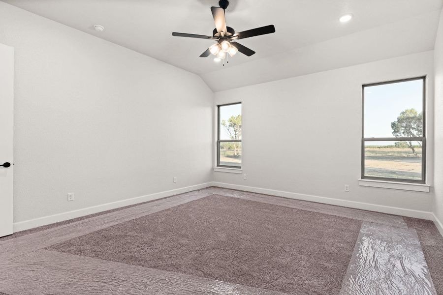 Empty room with lofted ceiling, a ceiling fan, and recessed lighting Empty room with lofted ceiling, a ceiling fan, and recessed lighting
