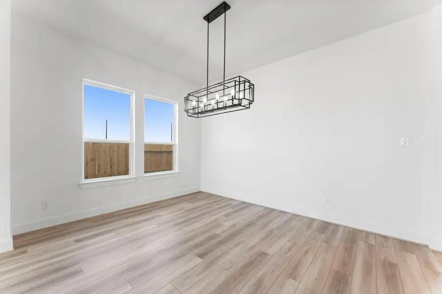 The Dining Room with LVP Flooring and Modern Chandelier