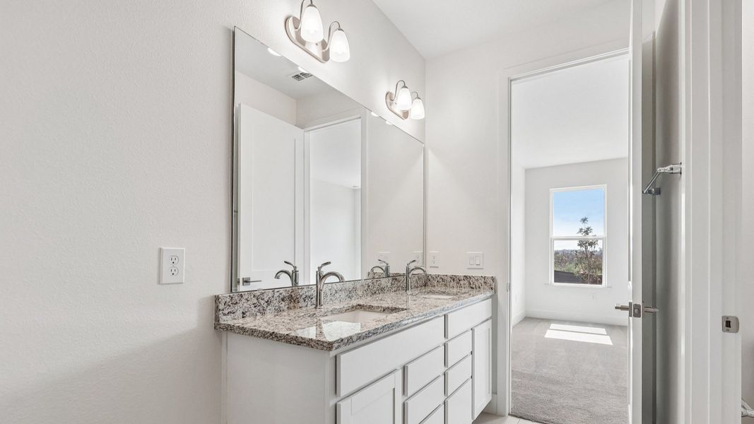 Acacia Floor Plan Primary En Suite Bathroom showcasing Dual Vanity in New Home Community Lakeside at Satilla in St. Cloud, FL Acacia Floor Plan Primary En Suite Bathroom showcasing Dual Vanity in New Home Community Lakeside at Satilla in St. Cloud, FL