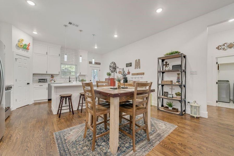 Dining room featuring washer / clothes dryer, dark wood-type flooring, and recessed lighting