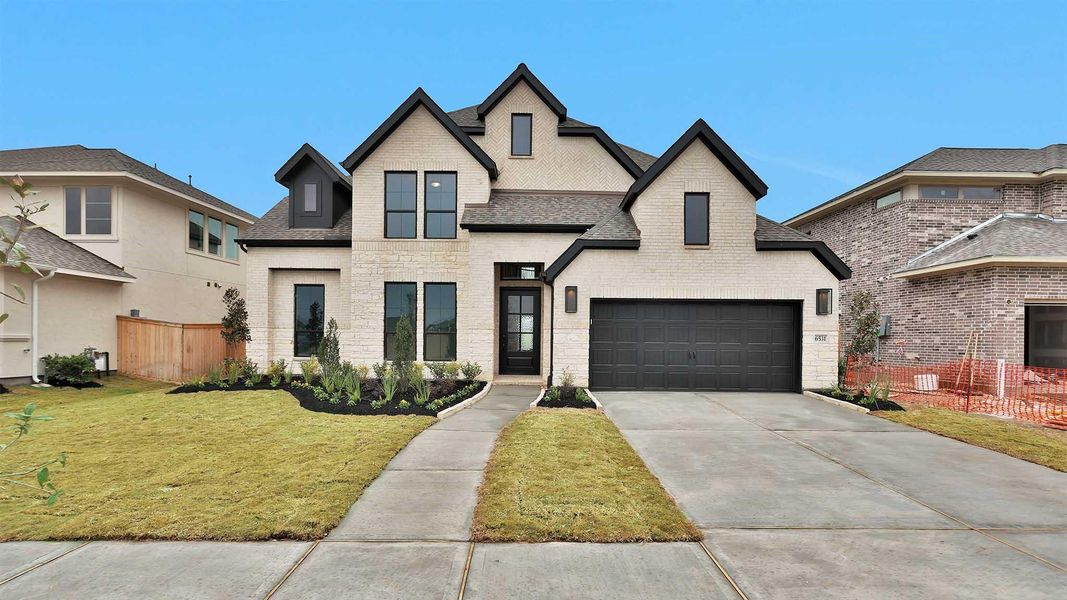 Front exterior of a new home in Valencia, Manvel, TX, highlighting curb appeal (Image 2).