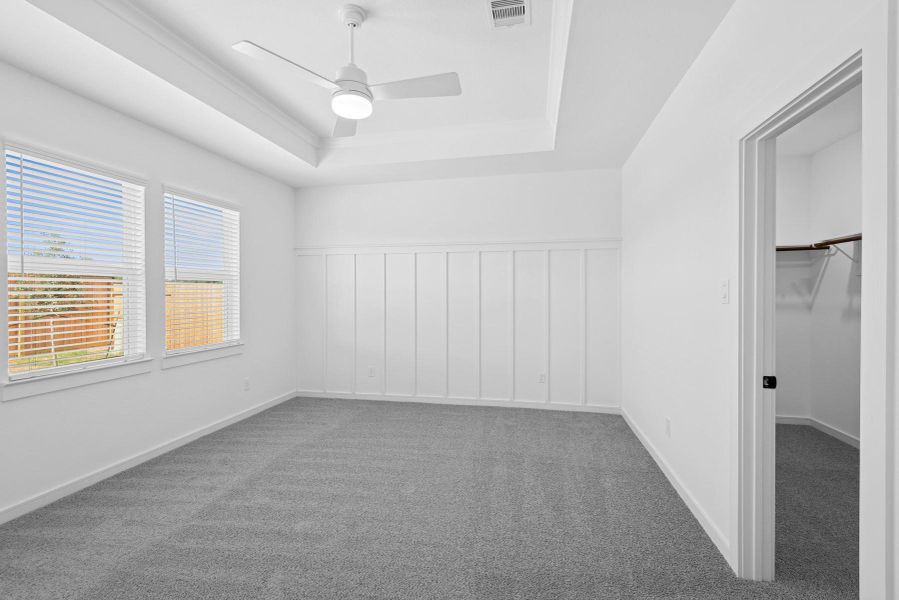 Private primary suite with feature wall