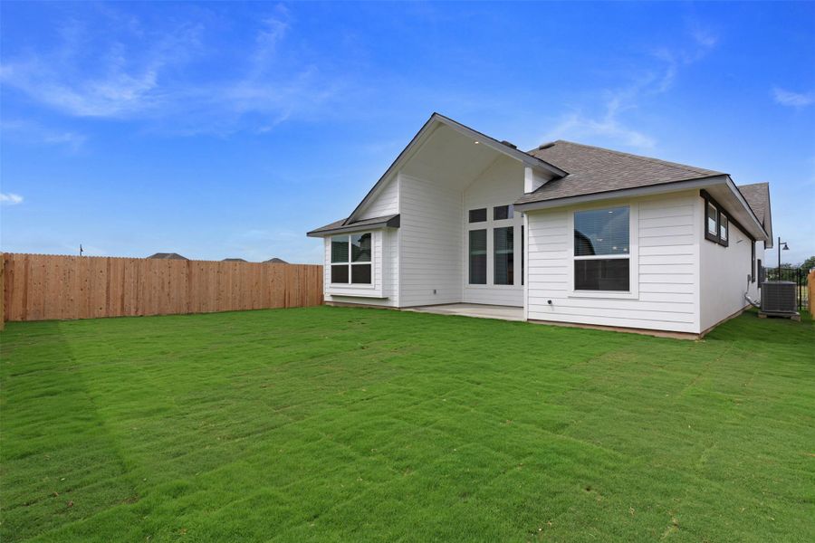 A spacious, newly sodded lawn offers ample outdoor living space behind a contemporary-style home. A spacious, newly sodded lawn offers ample outdoor living space behind a contemporary-style home.
