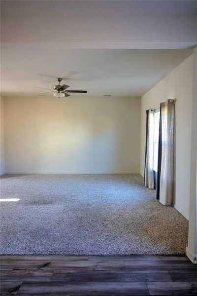 Empty room featuring wood finished floors and ceiling fan