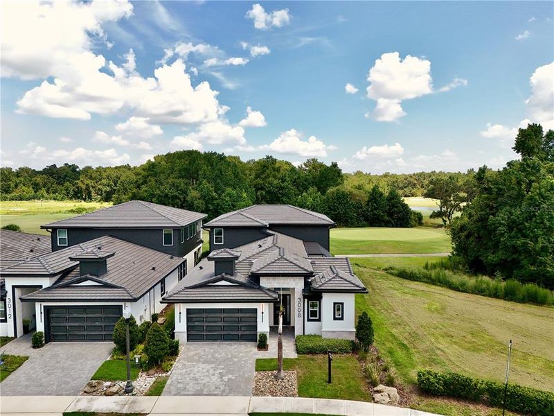 Front exterior of a new home in Hampton Green at Providence, Davenport, FL, highlighting curb appeal (Image 22). Front exterior of a new home in Hampton Green at Providence, Davenport, FL, highlighting curb appeal (Image 22).