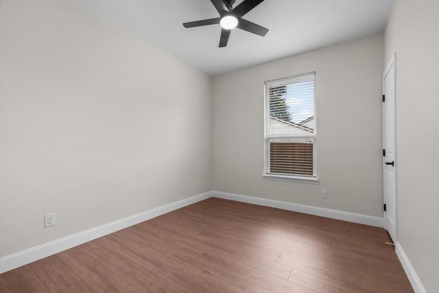 Empty room with ceiling fan and hardwood / wood-style floors