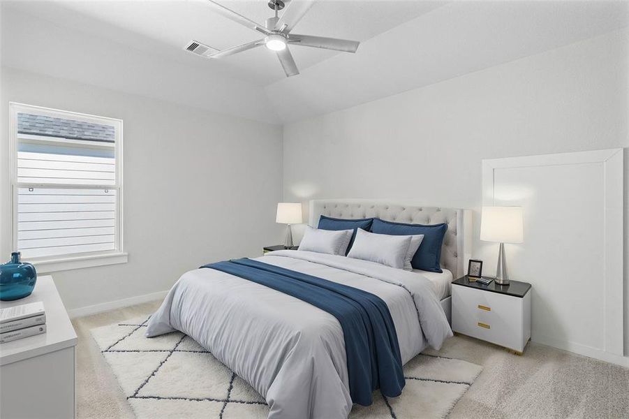 Secondary bedroom features plush carpet, custom paint, ceiling fan with lighting and a large window with privacy blinds.